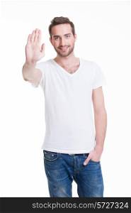 Young happy man requiring stop with his hand - isolated on white.
