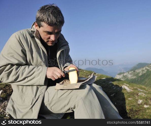 young happy, man slice fresh milk product cheese outdoor in nature