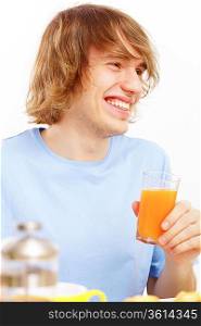 Young happy man smiling and drinking juice