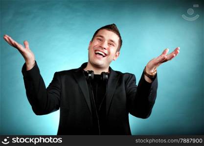 Young happy man student music lover with headphones blue background