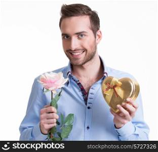 Young happy man with a pink rose and a gift - isolated on white.
