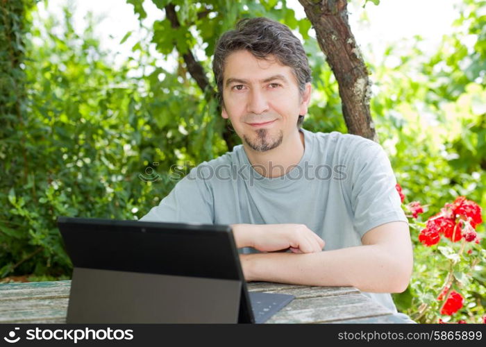 young happy man with a tablet pc, outdoor