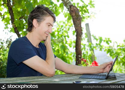 young happy man with a tablet pc, outdoor