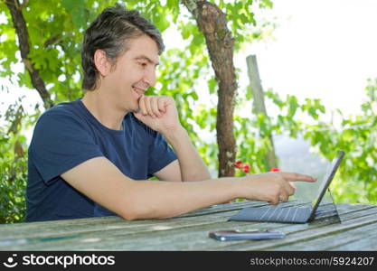 young happy man with a tablet pc, outdoor