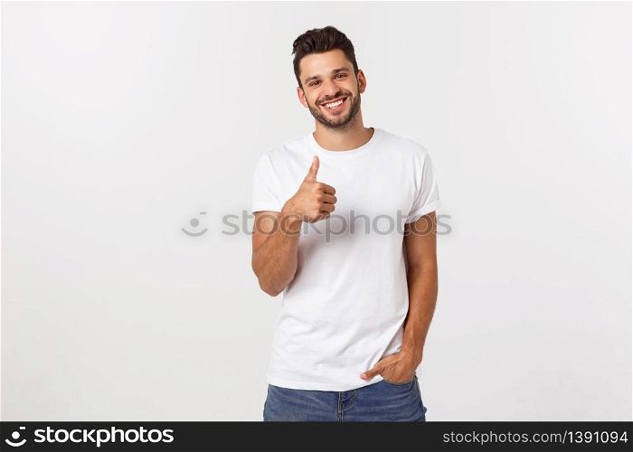 Young happy man with thumbs up sign in casuals isolated on white background.. Young happy man with thumbs up sign in casuals isolated on white background
