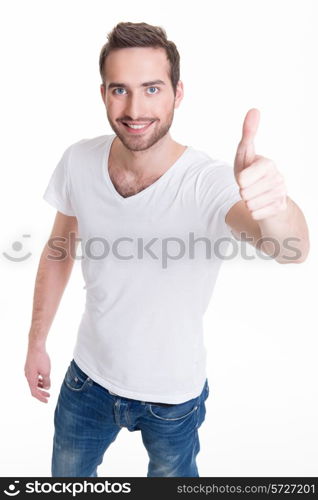 Young happy man with thumbs up sign in casuals isolated on white background.