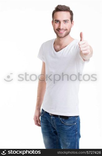 Young happy man with thumbs up sign in casuals isolated on white background.