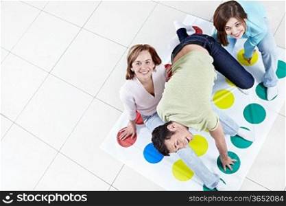 Young happy people playing twister