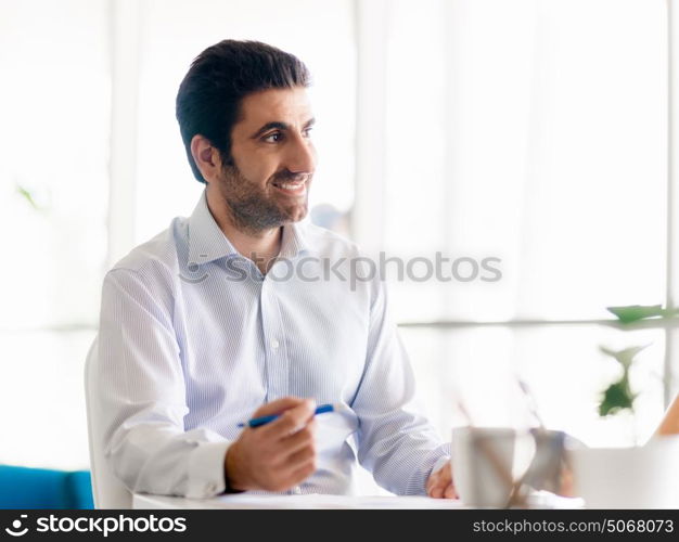 Young happy professional in office