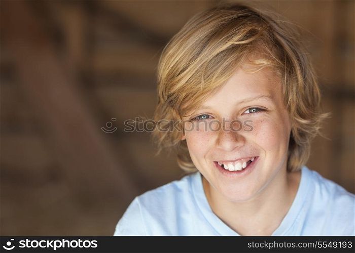 Young happy smiling blond boy child aged about 12 or early teenager