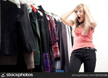 Young happy woman has a plenty of clothes to choose from