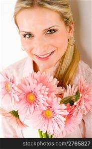 Young happy woman hold bunch of pink gerbera daisy romantic