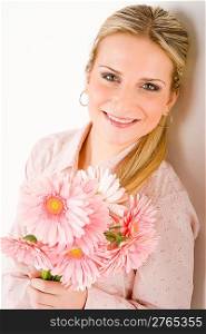 Young happy woman hold pink gerbera daisy romantic