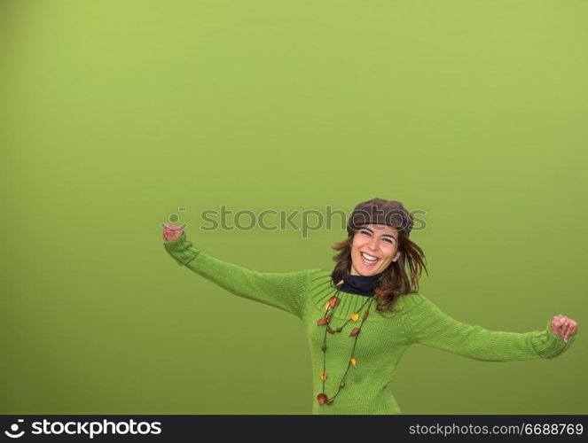 Young happy woman in a green background