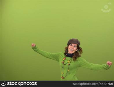 Young happy woman in a green background