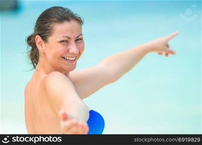young happy woman in bikini calls in the sea