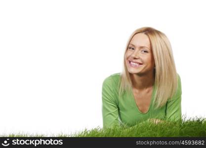 Young happy woman lying on spring grass, isolated on white background