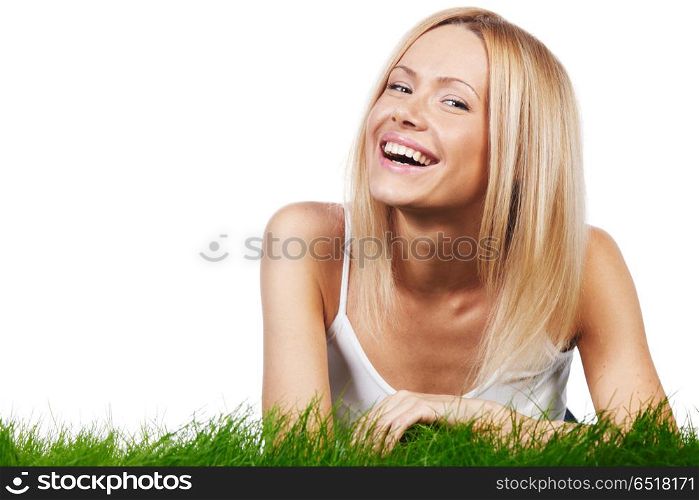Young happy woman lying on spring grass, isolated on white background. Happy woman on grass