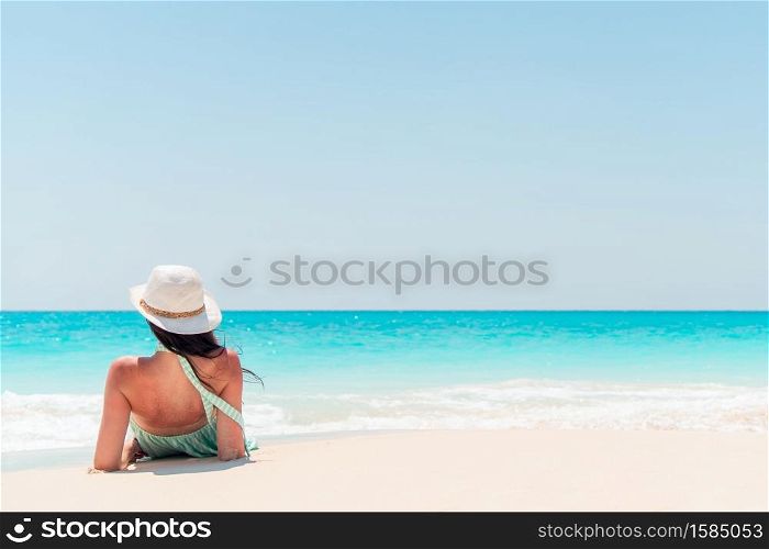Young happy woman on beach vacation. Young fashion woman in green dress on the beach