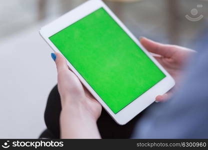 young happy woman on sofa using tablet computer at luxury home