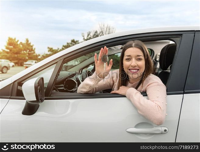 Young Happy Woman Showing The Key Of her New Car