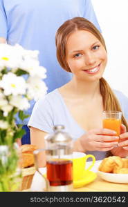 Young happy woman smiling and drinking juice