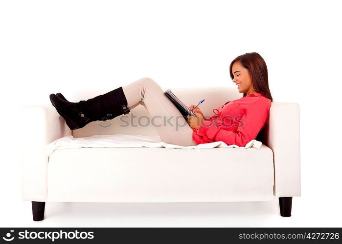 Young happy woman studying on a couch