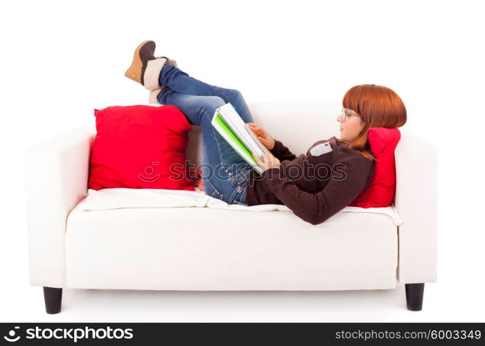 Young happy woman studying on a couch