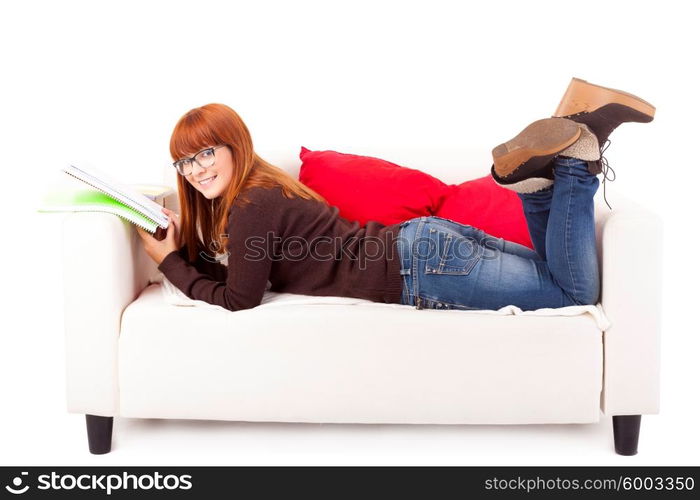 Young happy woman studying on a couch