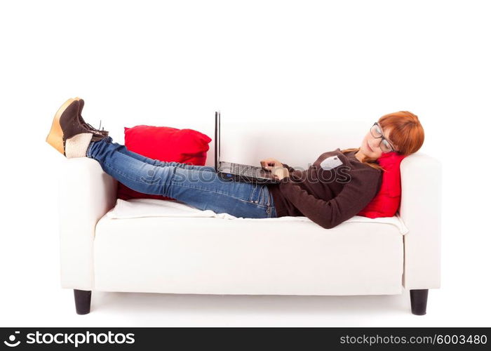 Young happy woman studying on a couch