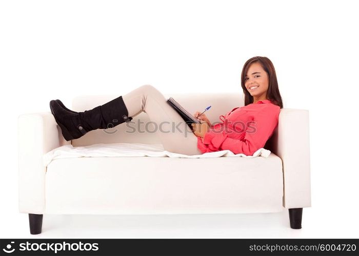 Young happy woman studying on a couch