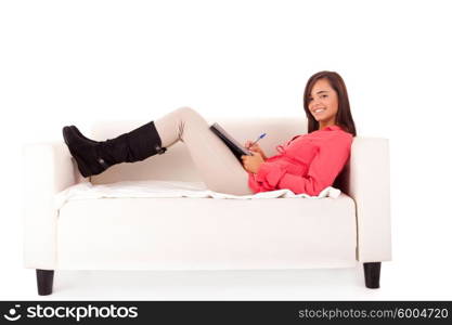 Young happy woman studying on a couch