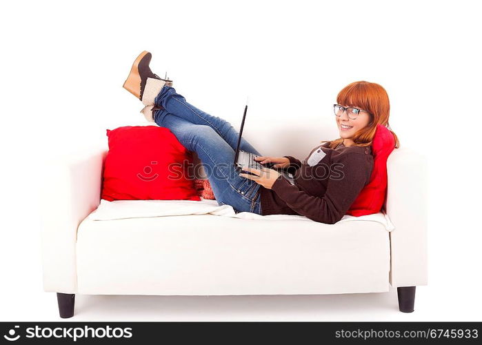 Young happy woman studying on a couch