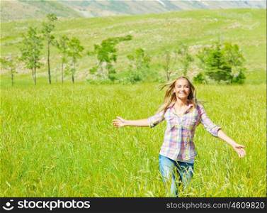 Young happy woman walking on wheat field, cute teen runs on green grass field, carefree girl enjoying peaceful countryside nature, beautiful smiling female have recreation in park, freedom concept