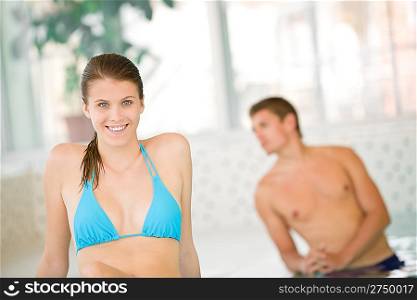Young happy woman wear bikini relax in spa in luxury hotel