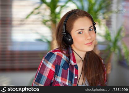 Young happy woman wearing headphones