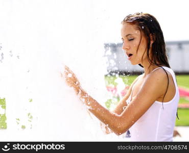 Young happy woman wet in the rain