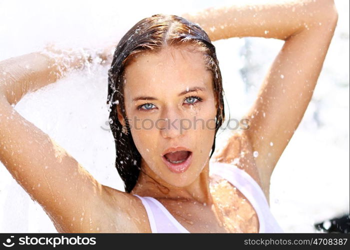 Young happy woman wet in the rain