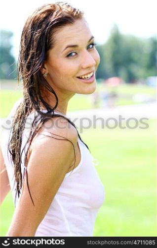 Young happy woman wet in the rain