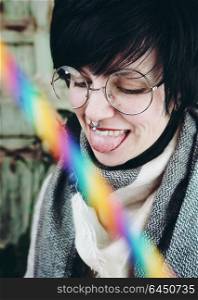 Young happy woman with a rainbow straw