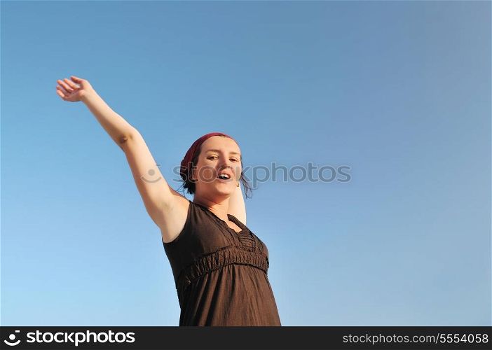 young happy woman with arms wide open representing freedom concept