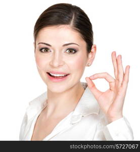 Young happy woman with ok sign in white shirt isolated on white background.