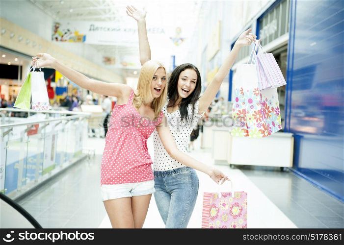 Young happy women with shopping bags