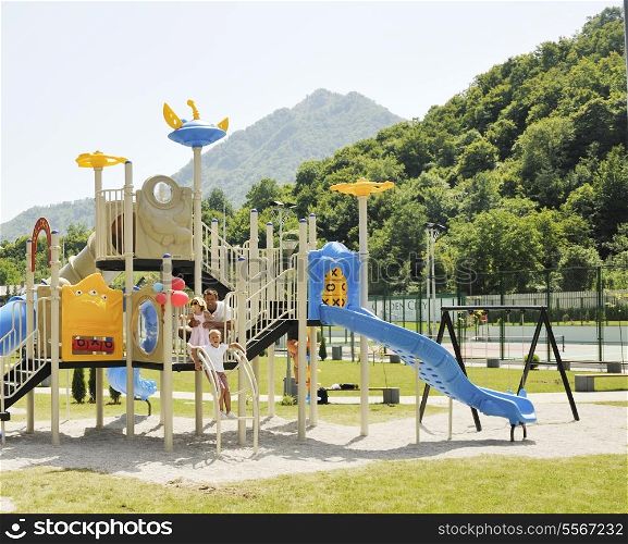 young hapy family portrait at park playground