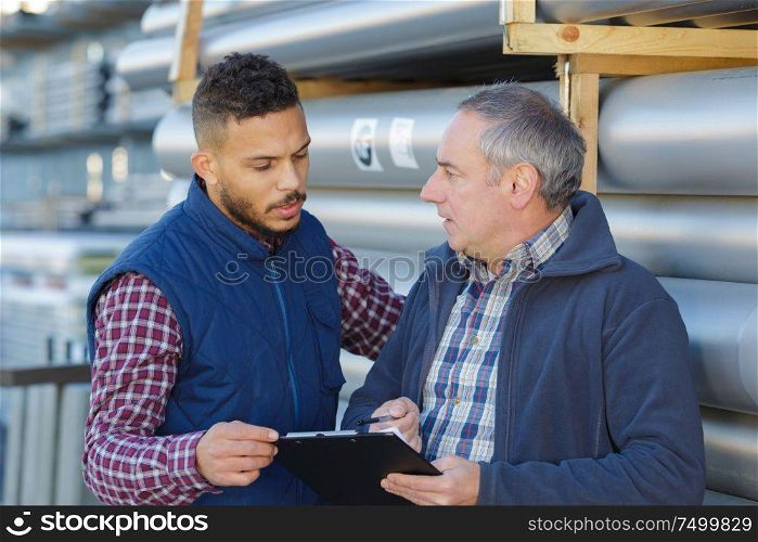 young harbor container depot worker talking to manager