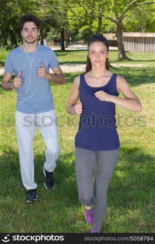 young health couple jogging in the park