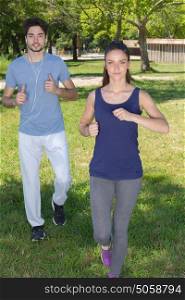 young health couple jogging in the park