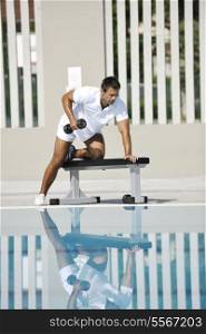 young healthy athlete man exercise at poolside
