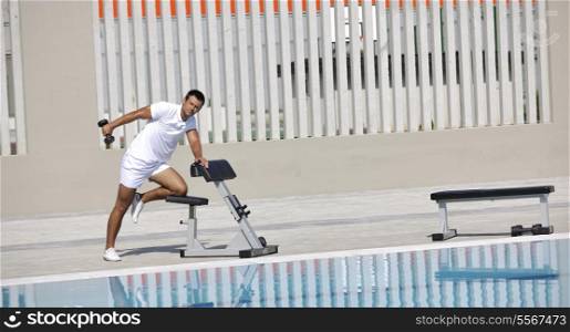 young healthy athlete man exercise at poolside