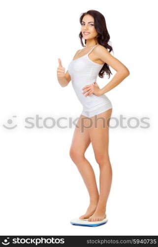 Young healthy girl on home scales isolated